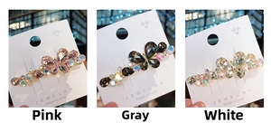 Detailed macro view of colorful butterfly hair clips with sparkling crystal rhinestones