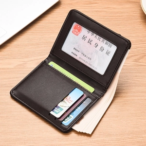 Slim black leather men's wallet featuring multiple card slots and an ID window on wood