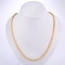 Close-up of minimalist 18K gold plated twisted rope chain necklace on white display stand