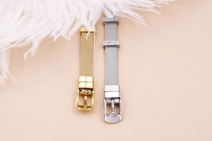 Detail of gold and silver mesh bracelets with crystal slide charms on soft feather backdrop