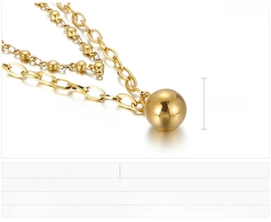 Macro detail of golden double-layer stainless steel chain with 12mm polished ball pendant