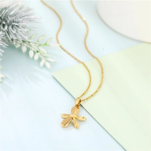 Close-up of a gold-plated flower pendant with textured petals on a stainless steel chain