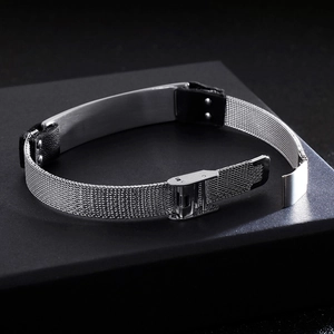 Silver stainless steel mesh bracelet with black leather detail on black geometric stage