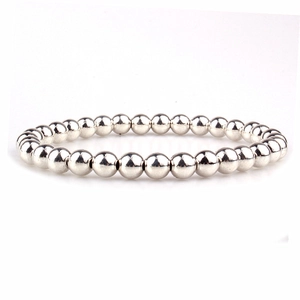 Close-up of polished silver 18K gold-plated copper beads on a minimalist strand bracelet