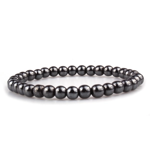 Detail shot of 18K gold plated beaded bracelet with polished deep grey metallic beads