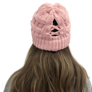 Close-up of pink ponytail beanie with hollow cross-strap design for hair buns