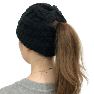 Detail view of the rear opening on black cable-knit beanie designed for ponytail hairstyle