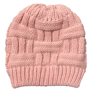 Detail of pink knitted beanie featuring chunky cable knit patterns and ribbed hem