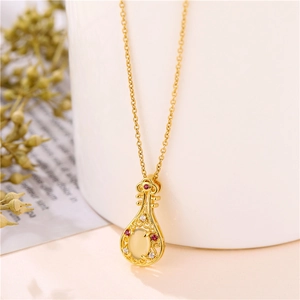 18K gold violin pendant necklace with cat-eye stone and zircons on white background