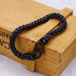 Close-up of black braided stainless steel dragon bone chain bracelet with U-shaped clasp