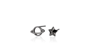 Macro shot of asymmetric black S925 sterling silver star and planet stud earrings