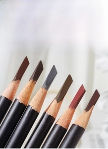 Macro detail of six professional wooden eyebrow pencils with flat angled blade tips