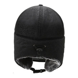 Winter thermal trapper hat in black faux leather with warm plush lining and ear flaps