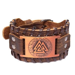 Brown leather Viking bracelet with Valknut metal plate and Norse runes on white background