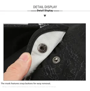 Detail showing the detachable face mask with snap buttons on the black textured winter hat
