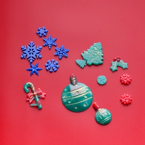 Flat lay of colorful Christmas resin charms including snowflakes and candy canes