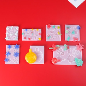 DIY Christmas silicone molds with resin snowflake and candy cane shapes on red background
