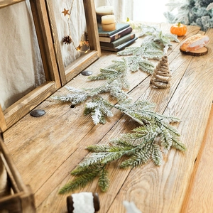 Snow-flocked cedar garland with artificial pine needles for Christmas home decoration