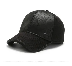 Detail of black winter baseball cap showing textured fabric and silver metal logo