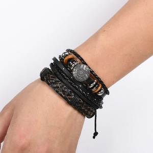 Detailed view of multilayer leather bracelet with tribal metal charms and wooden beads