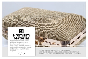 Detail of pleated gold evening clutch bag with metallic threads and spherical snap closure