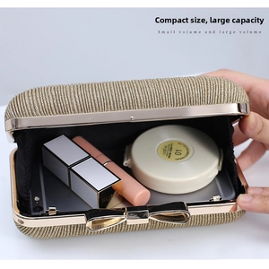 Close-up of golden evening clutch showing interior capacity for phone and makeup