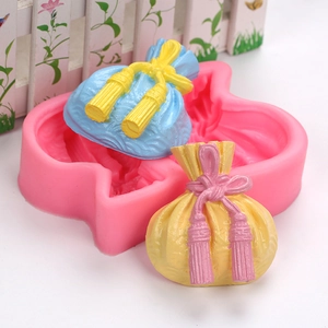 Detailed view of lucky bag silicone mold with intricate tassel and pleated texture detail