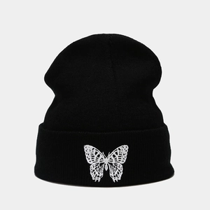 Classic black knitted beanie with white butterfly embroidery and folded cuff for winter