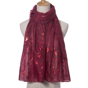 Detail of burgundy Christmas scarf with shimmering silver elk and snowflake prints