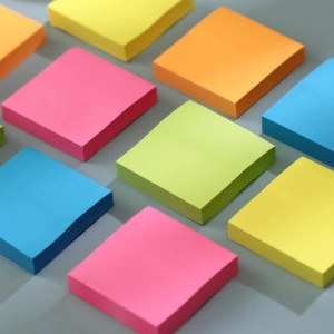 Detailed grid view of assorted colorful square mini sticky notes in pastel and neon tones