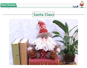 Detail of plush Santa Claus figure with knitted snowflake hat on a stack of red books