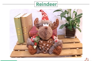Detailed view of plush reindeer Christmas ornament inside a brown gift box for holidays