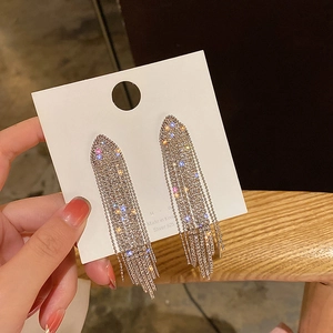 Detailed macro view of long 925 silver fringe earrings with sparkling geometric crystals