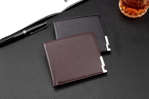 Detail of minimalist leather wallets in black and brown with silver metallic buckle accents