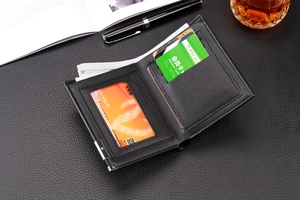 Macro shot of bifold black leather wallet interior with multiple card slots and clear ID window