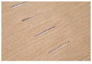 Macro view of camel knitted scarf showing hollow-out texture and fine stitching