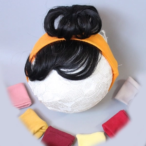 Close-up of baby hairband set with cute wig buns and colorful fabric bows