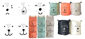 Detail showing various animal face expressions on canvas storage baskets and hanging bags