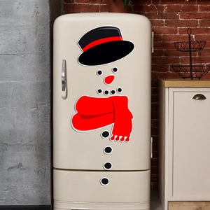 DIY Christmas snowman magnetic stickers on a vintage fridge in a cozy kitchen setting