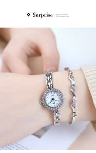 Detail of silver quartz watch with diamond bezel and colorful gemstone bracelet on wrist