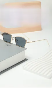 Detailed side view of irregular gold metal sunglasses with star decor and dark gray lenses