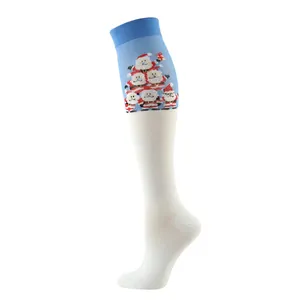 Detail of Christmas compression socks featuring Santa Claus patterns on knit fabric