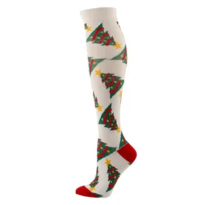 Christmas knee-high compression socks featuring festive green trees and red knit patterns