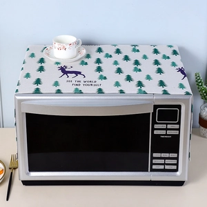 Close-up of linen microwave cover with reindeer pine tree prints and English quote