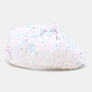 Detail of white beret featuring dense iridescent sequins and classic top stem texture
