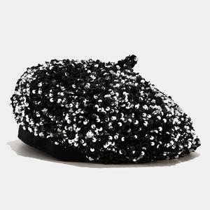 Close-up of black sequin beret showing detailed shimmering texture and fabric rim