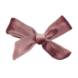 Detail of vintage dusty rose velvet bow with handmade knotted texture and silky sheen