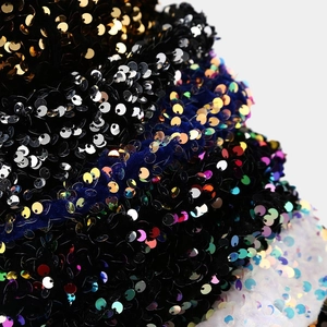 Close-up of high-density colorful sequins on velvet fabric for fashion berets