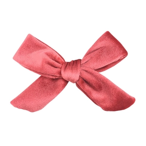 Close-up of handmade velvet bow in dusty rose with detailed fabric texture and knot