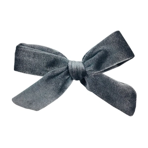 Detailed view of the dark gray velvet texture on a classic handmade bow hair accessory